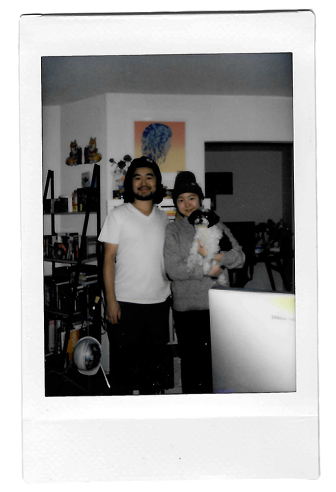 A polaroid of the founder and her husband, holding their small black and white dog.